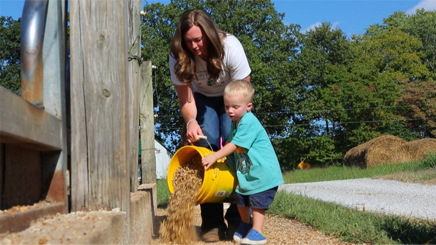 Caroline Holt and son feeding 