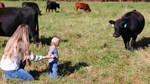 MiCayla Giffin and son in the field with cattle