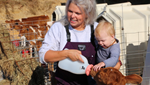 Emmy Lou Armstrong and baby bottle feeding a calf